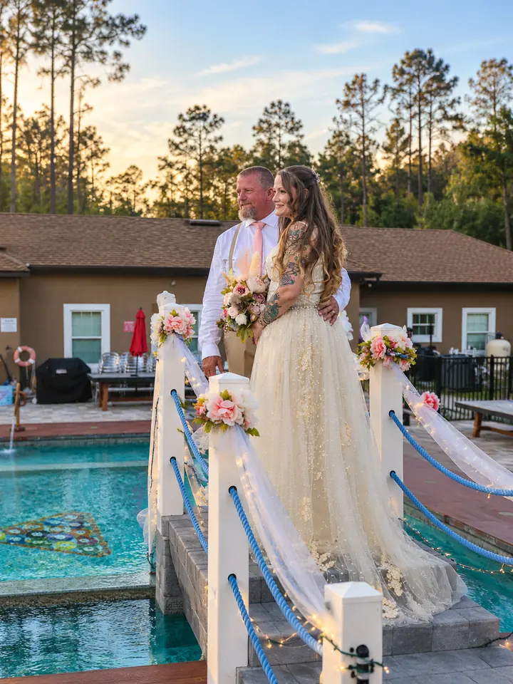 The newlyweds on the decorated pool bridge