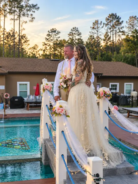 The newlyweds on the decorated pool bridge
