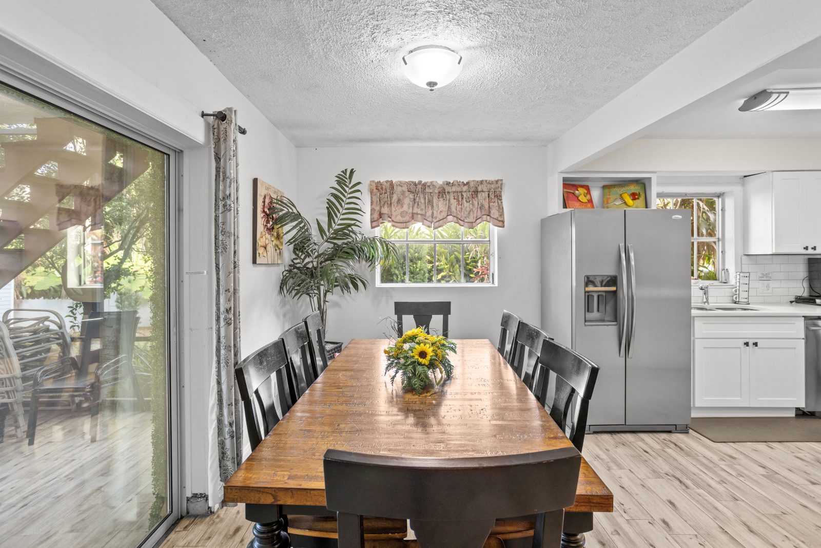 Dining area with large wood table for eight beside the kitchen