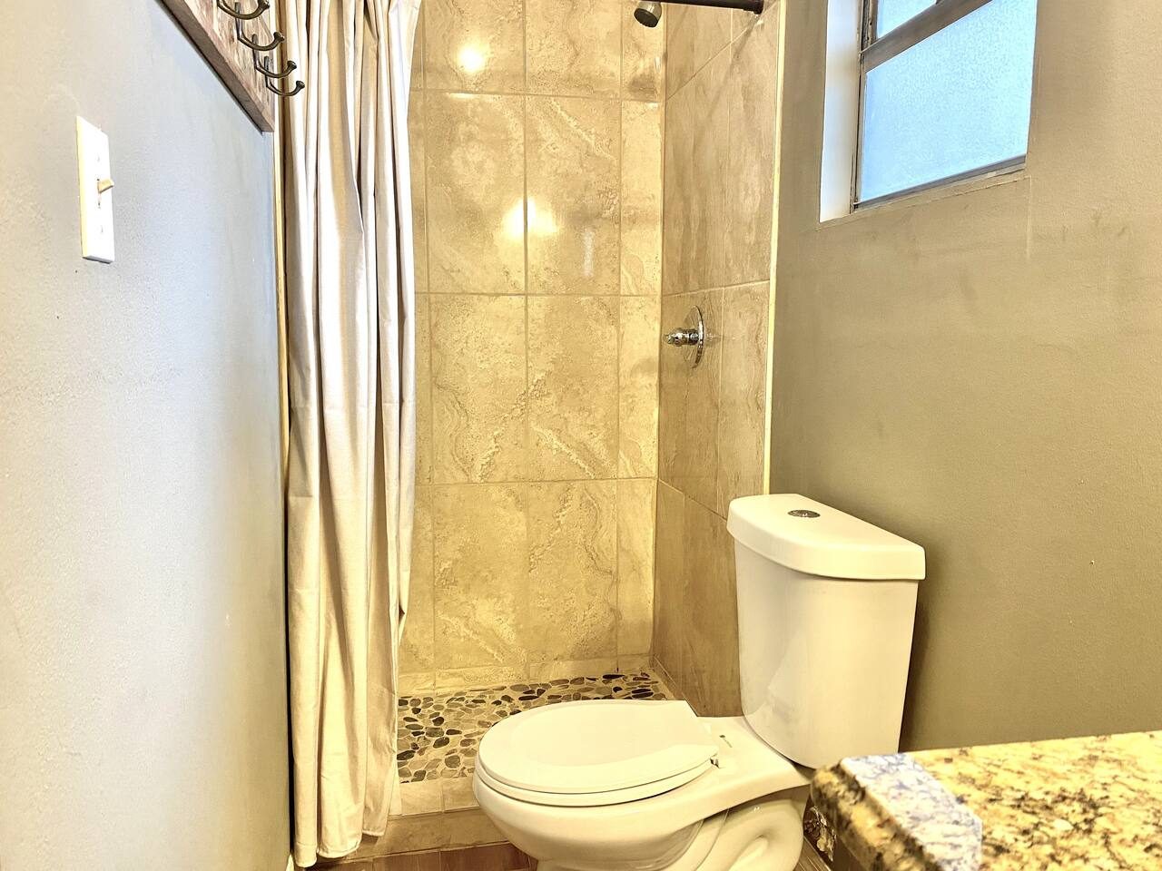 Rinse off the lake day in a sleek tiled walk-in shower.