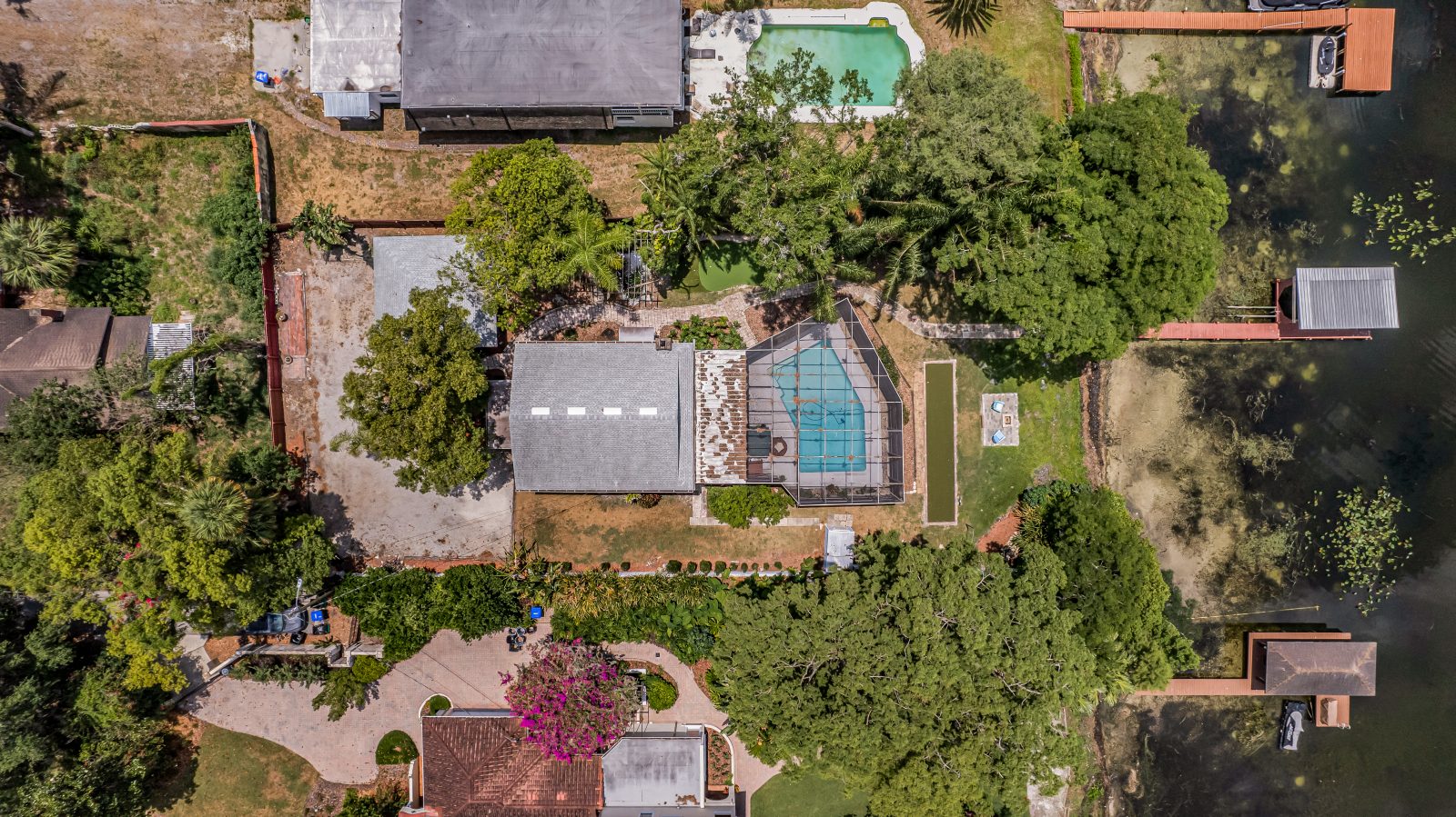 See the gated lakefront estate spread out beneath the trees.