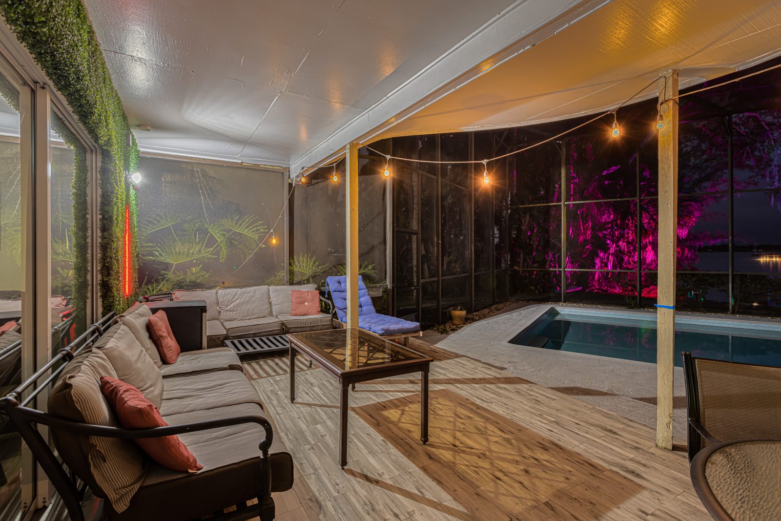 Unwind on the covered deck as the pool shimmers at night.