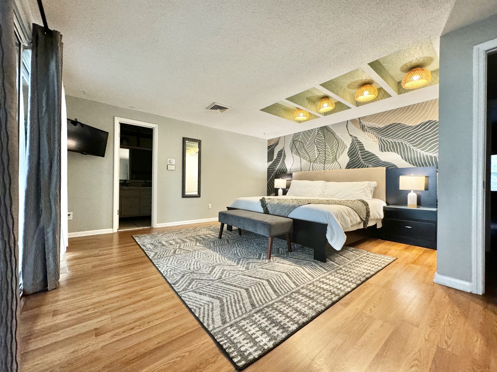 Retreat to the king Masters suite with its leafy mural.