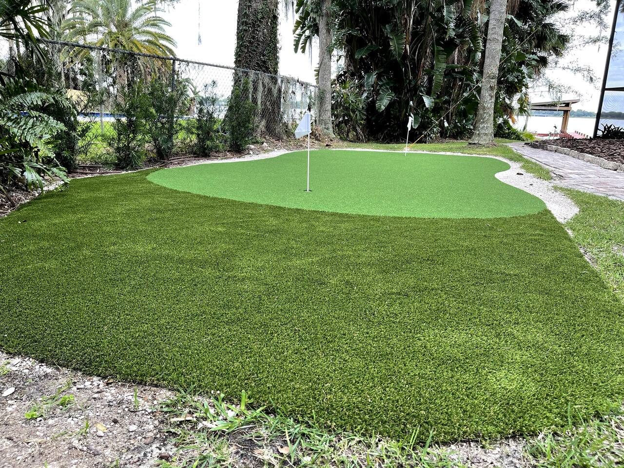 Sink a putt on your own backyard putting green by the lake.
