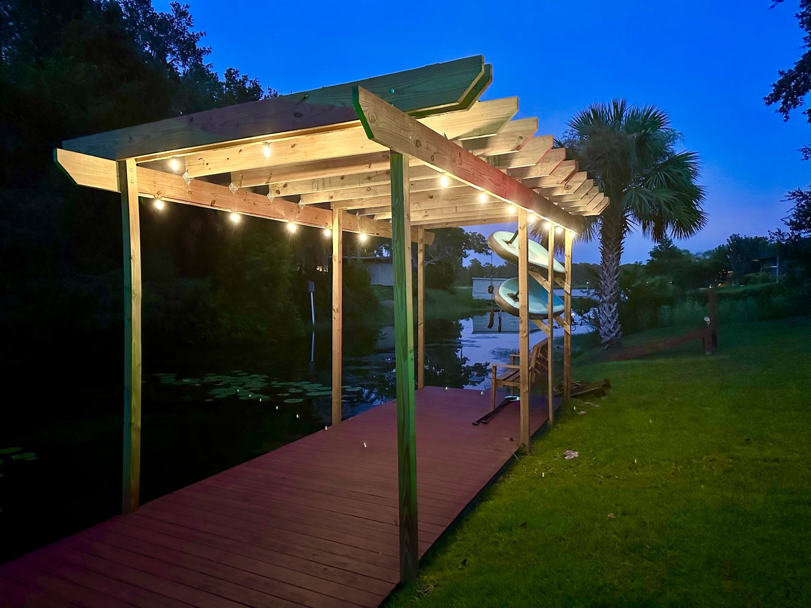 String lights and still water at dusk