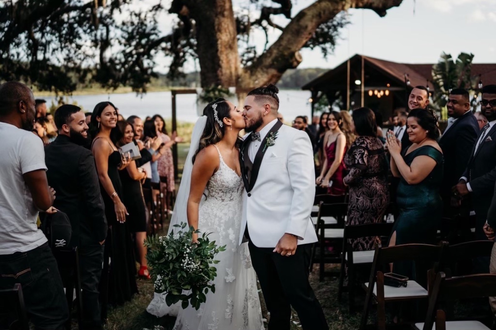 A wedding ceremony on the lakeside lawn at Lake Lucy Estate