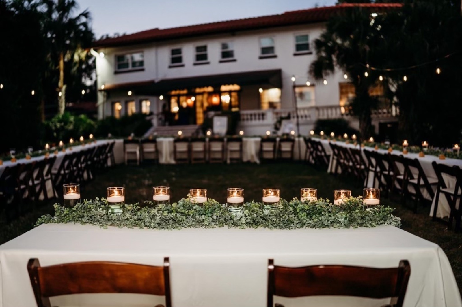 Candlelit reception table under the oaks at Lake Lucy Estate