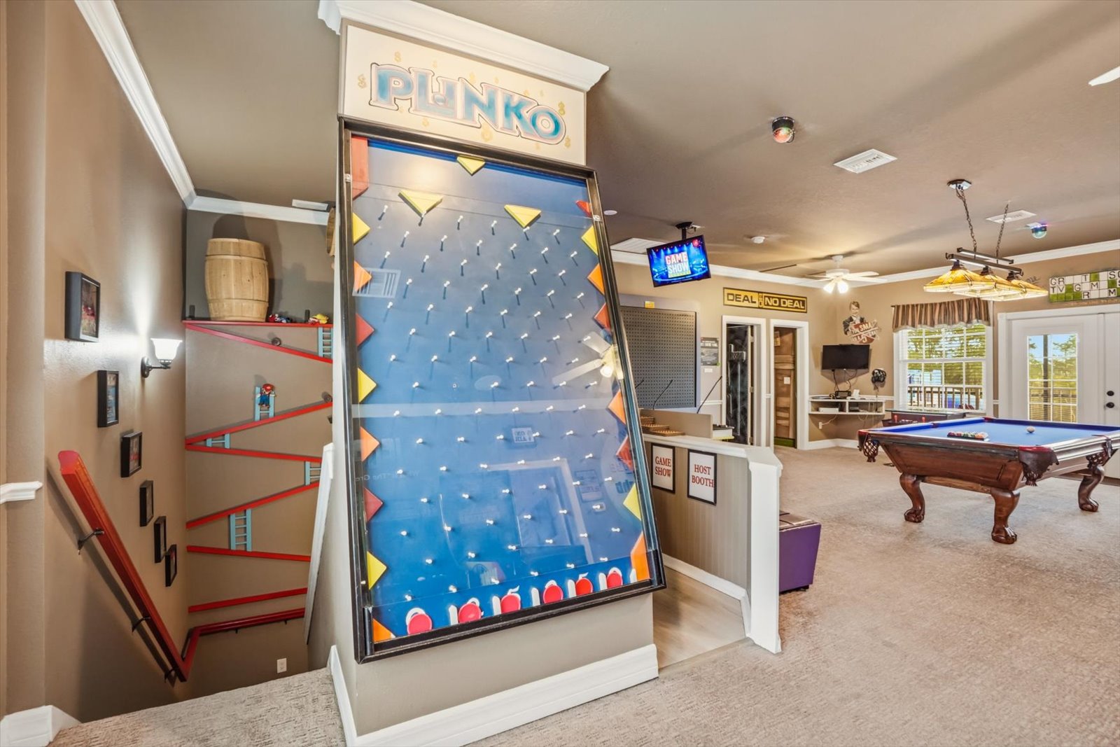 The full-size Plinko board at the top of the stairs
