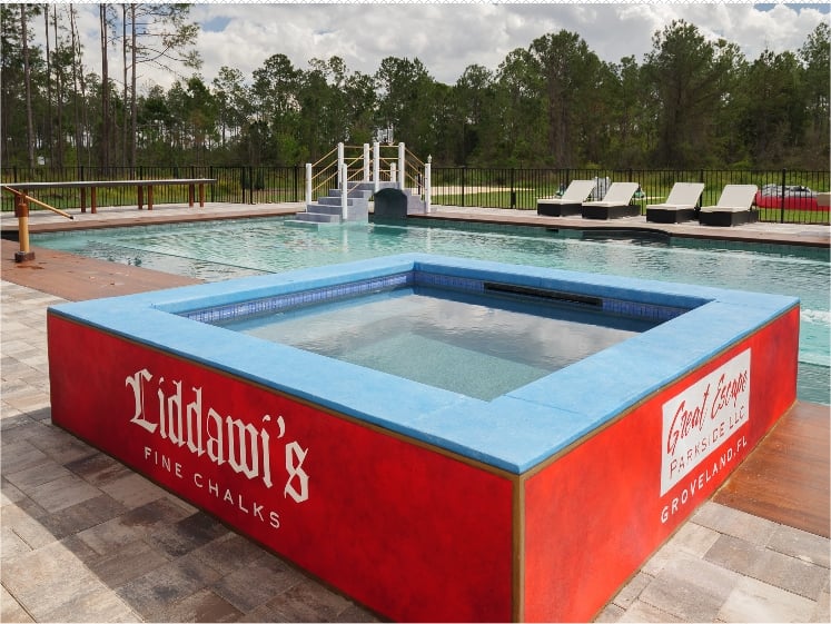 The chalk cube hot tub on the pool's ledge.