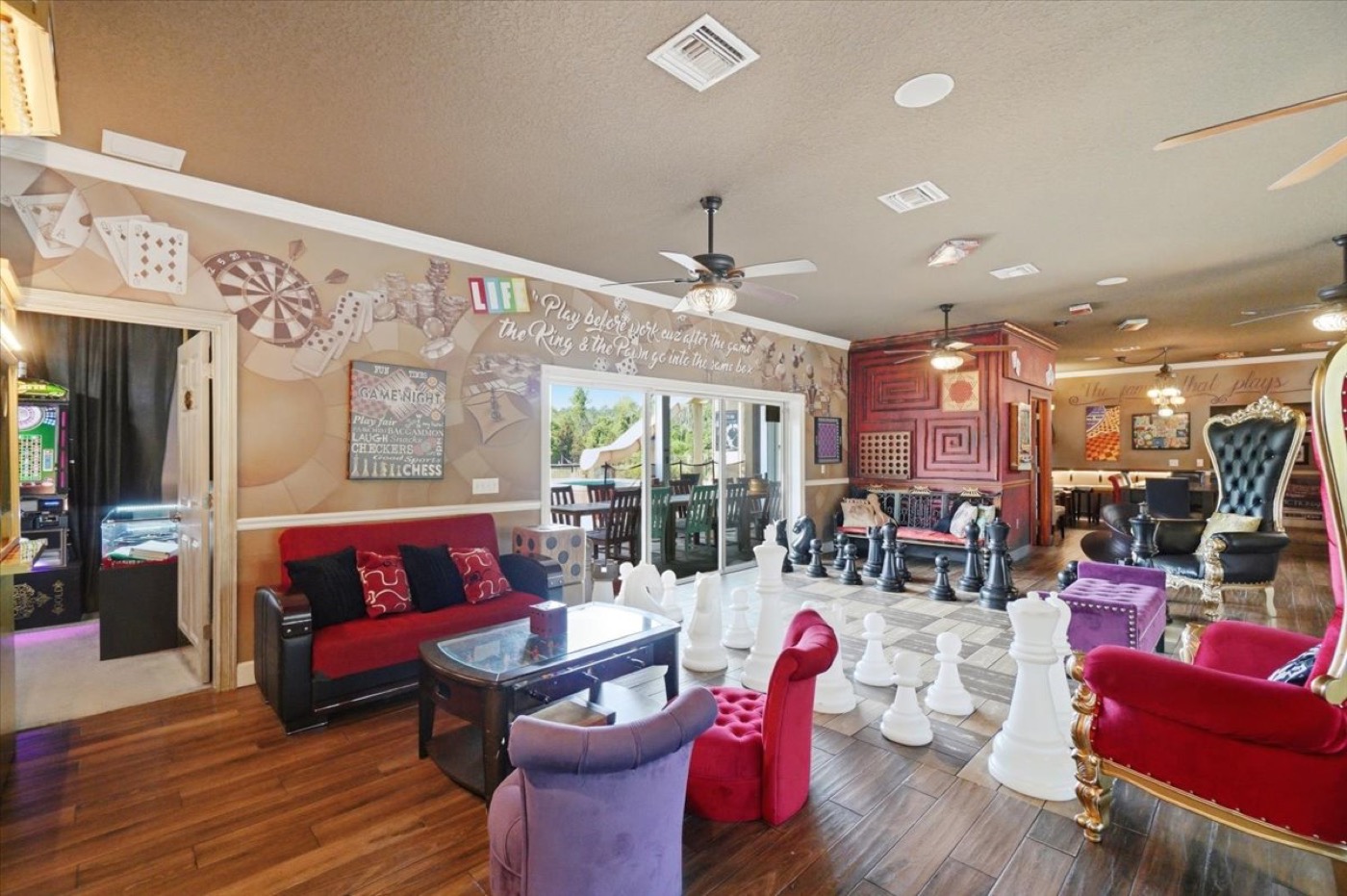 The red sofa and giant chess set, arcade room just beyond.