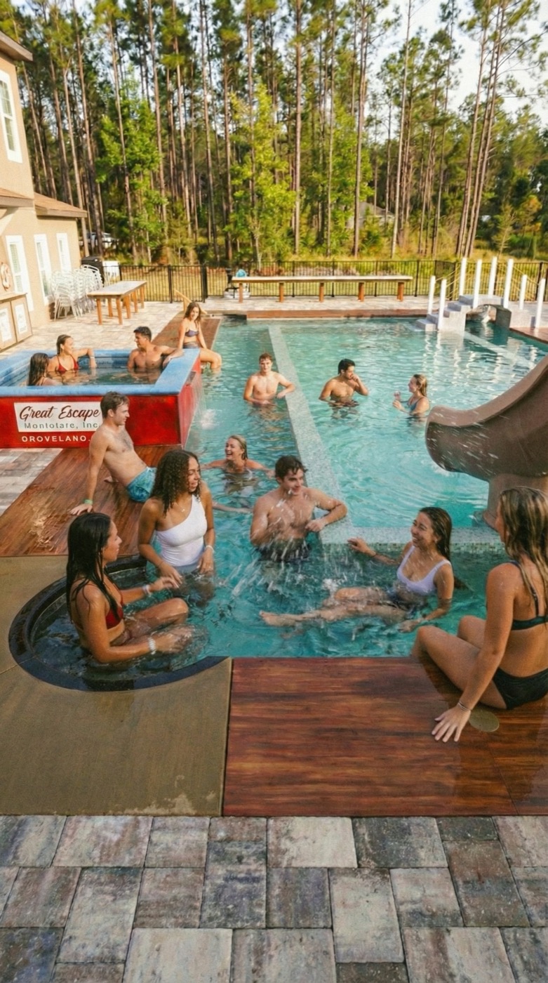 The whole group in the pool by the slide.