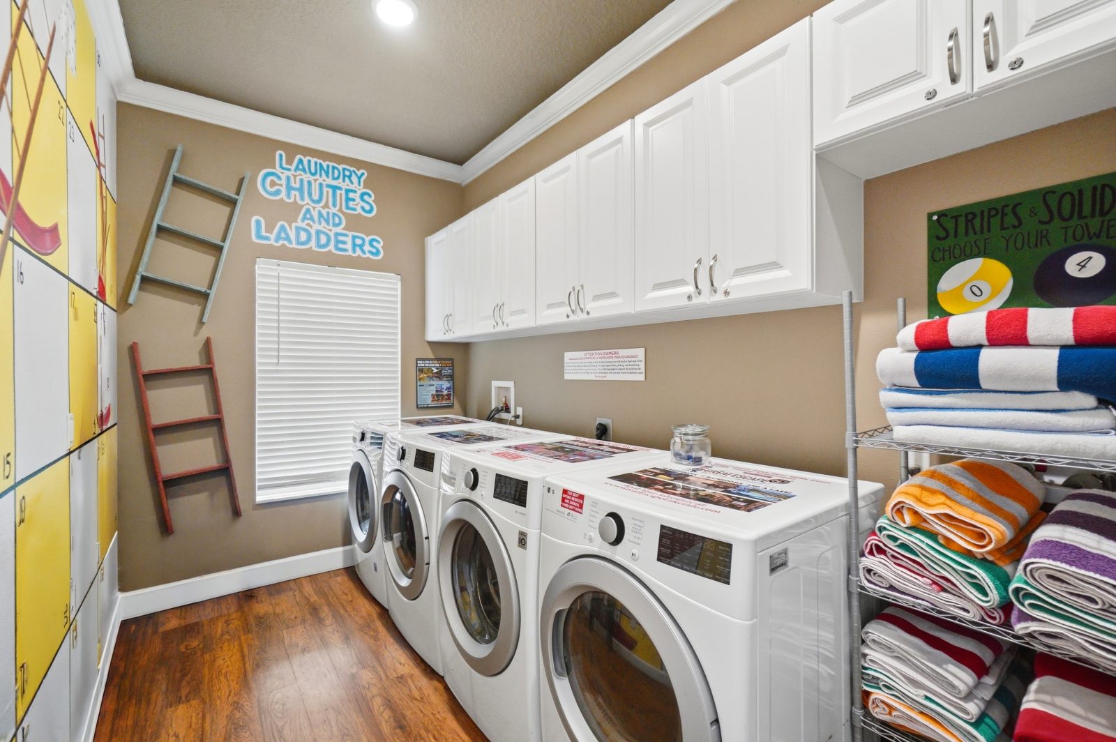 Convenient laundry room with 2 washers and 2 dryers.