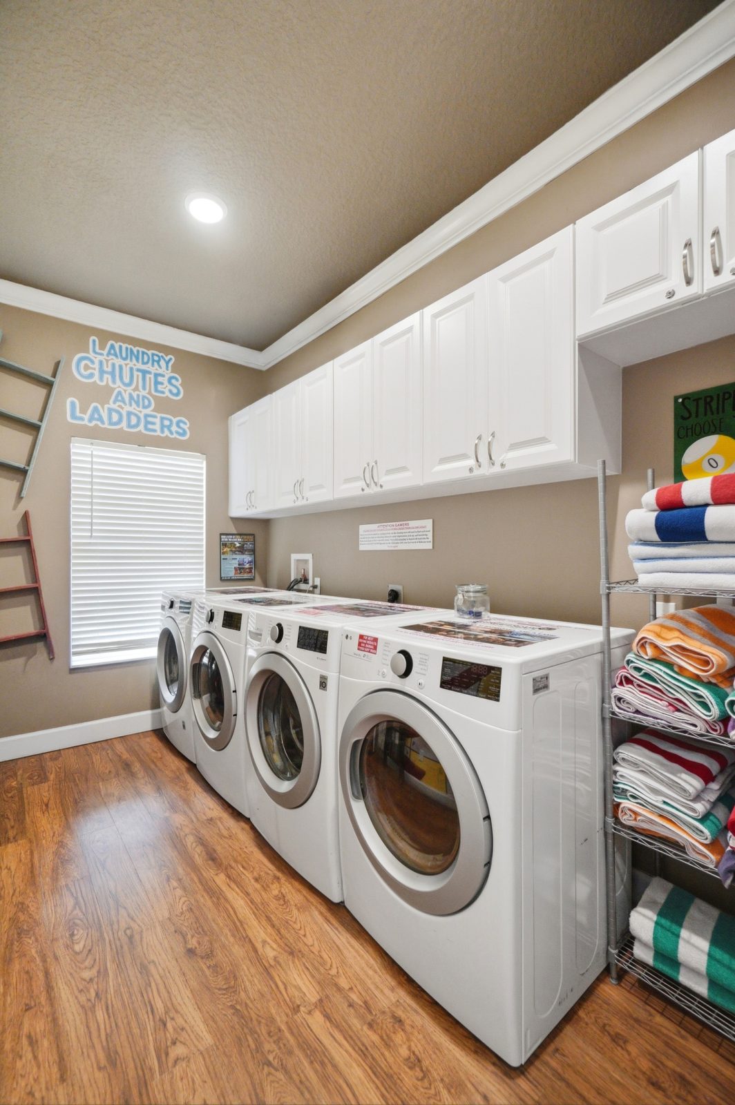 Convenient laundry room with 2 washers and 2 dryers.